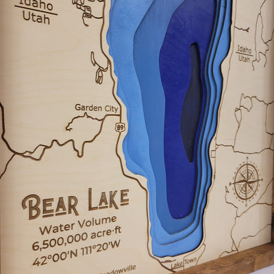 up close details of Bear Lake wooden map displaying engravings of title, blue water layering, and map details