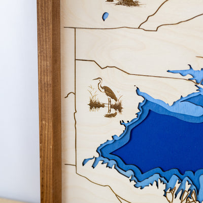 Wooden map of Bear Lake zoomed in on layered blue water and engraved details