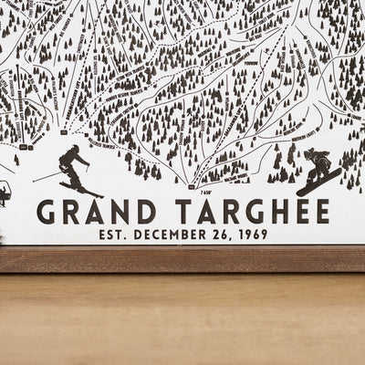 close up of Wooden ski map of Grand Targhee with engraved trails and skier silhouettes, including resort name and date