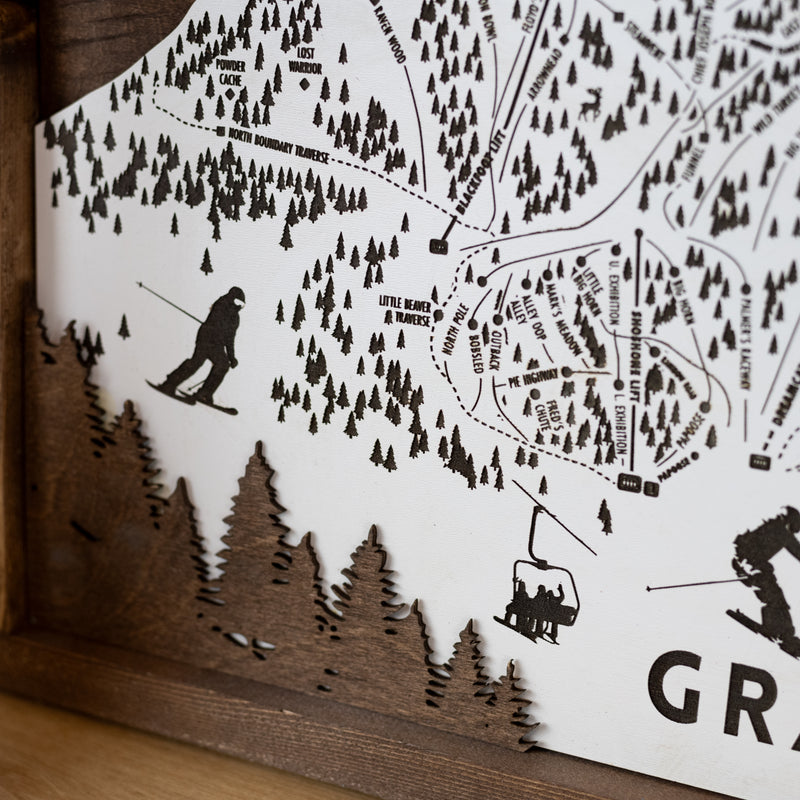 close up of Wooden ski map of Grand Targhee with engraved trails and skier silhouettes