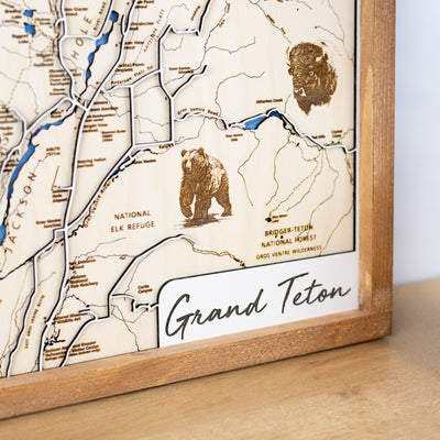 Close up of Grand Teton National Park wooden map featuring title, wildlife, trail names, and other landmarks