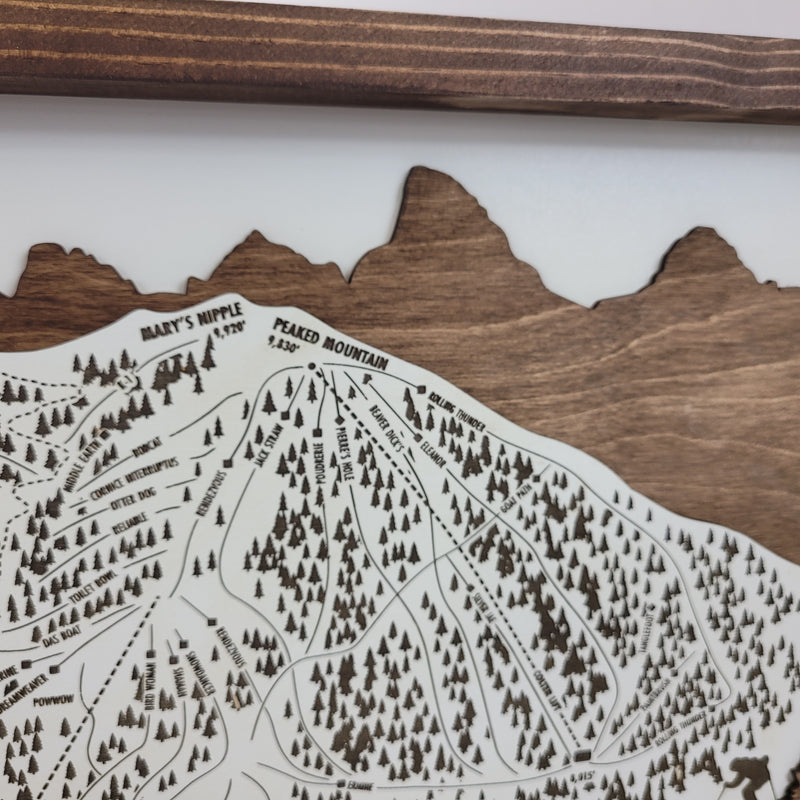 close up of Wooden ski map of Grand Targhee with engraved trails and mountain peaks 